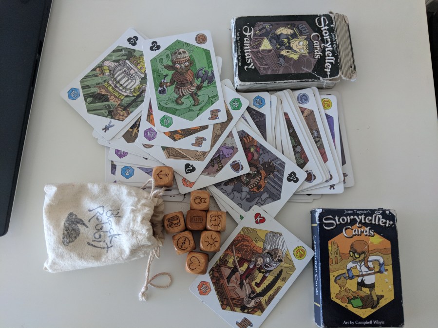 pile of storyteller cards and icon dice