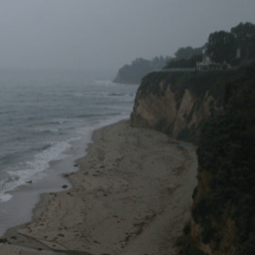 Rainy beach with cliffs