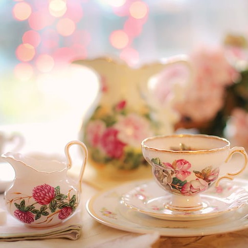 Ornate white teaset with pink floral decoration