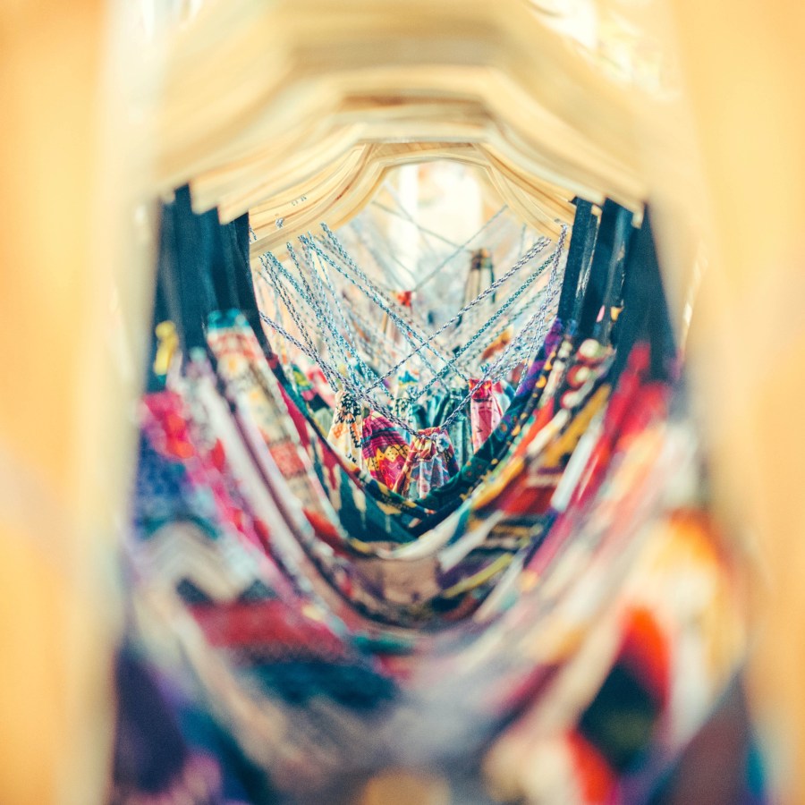 rack of dresses shot through the hangers by inspirationfeed-PsxNKud0ucg-unsplash